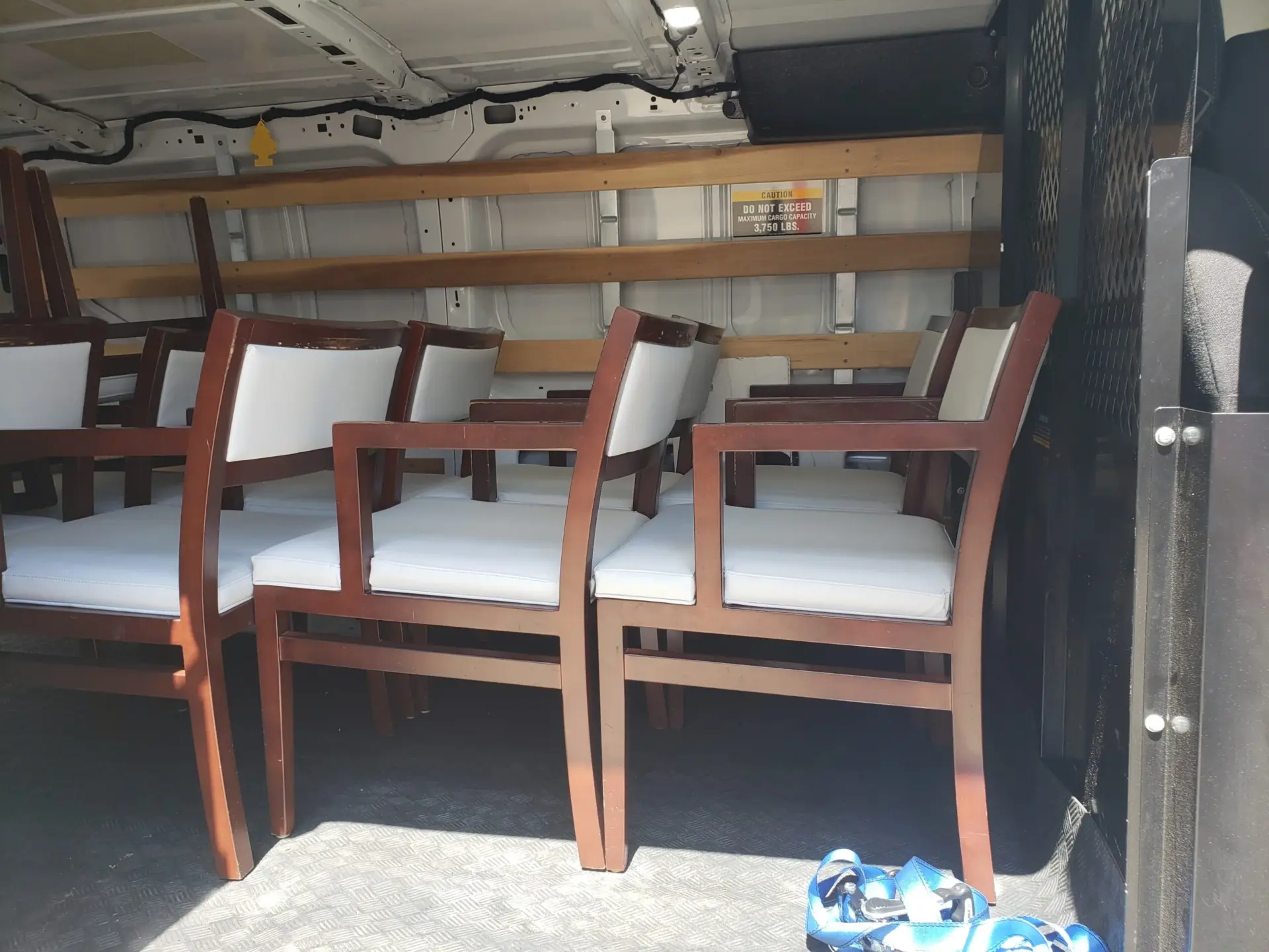 Batch of renewed commercial chairs loaded together for transportation