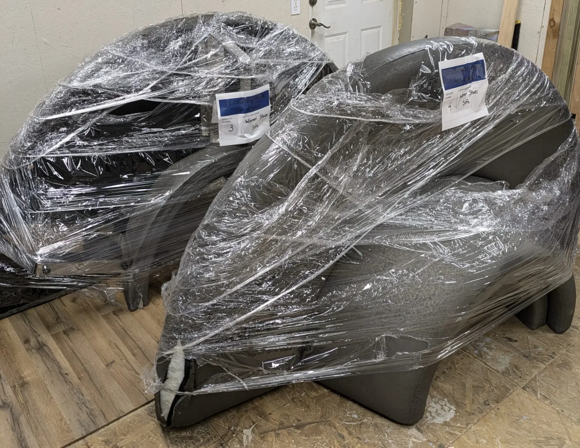 Commercial furniture wrapped, labeled, and staged for coordinated project handling
