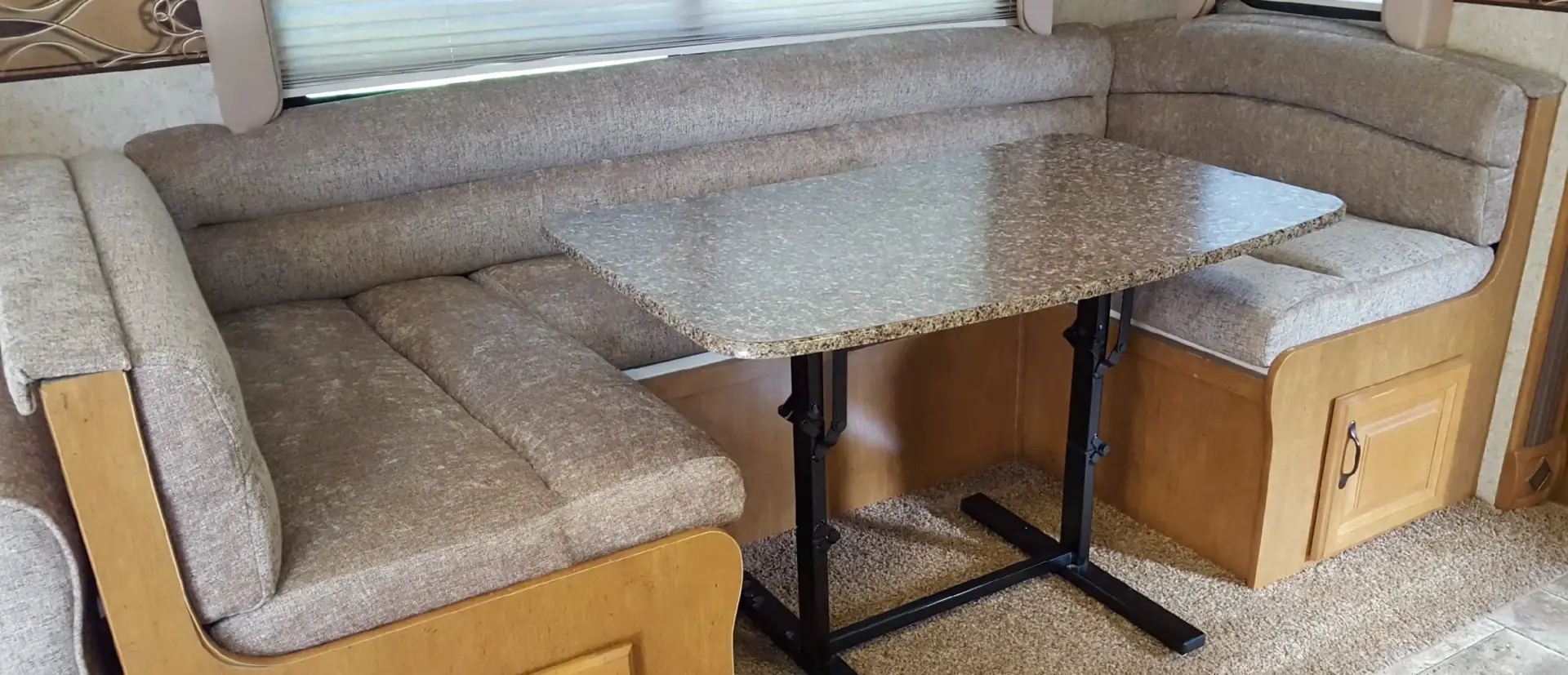 RV dinette with upholstered built-in benches surrounding the existing table and cabinetry