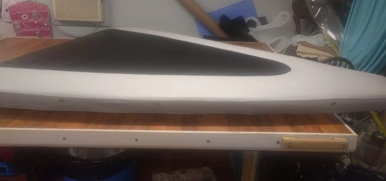 Restored boat seat cushion with custom black and white marine upholstery